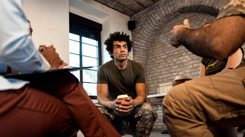 Group Of Diverse Veterans Talking During Ptsd Support Session